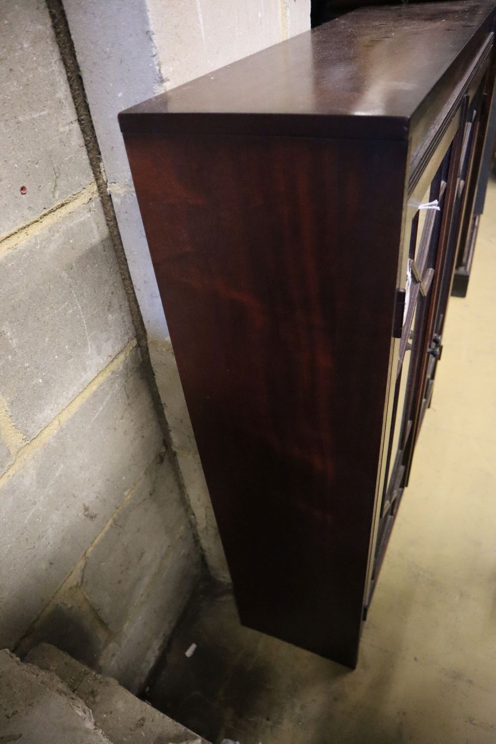 A reproduction mahogany bookcase, with astragal glazed doors, width 81cm, depth 25cm, height 102cm